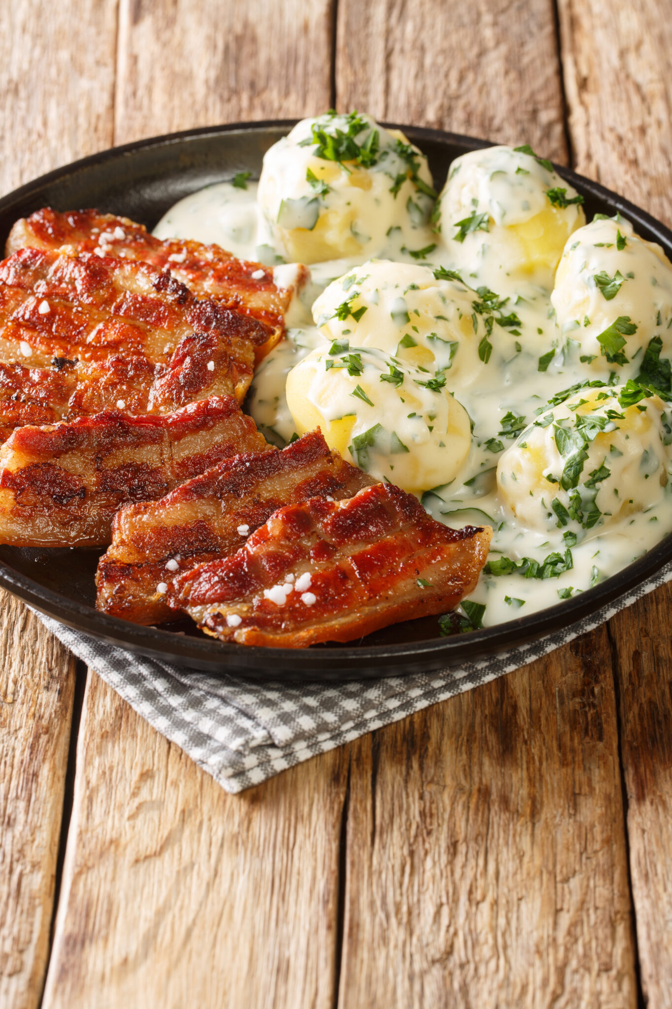 Stegt flæsk is a dish from Denmark consisting of fried pork belly and generally served with potatoes and a white sauce with parsley